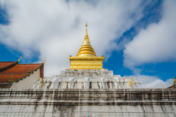 Fototapeta premium The golden stupa at Wat Phra That Chang Kham Worawihan or Phrathat Chang Kham Worawihan temple is the one attraction and has famous of Nan province, Thailand