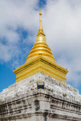 Fototapeta premium The golden stupa at Wat Phra That Chang Kham Worawihan or Phrathat Chang Kham Worawihan temple is the one attraction and has famous of Nan province, Thailand