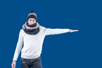 White man in hat and scarf with outstretched hand