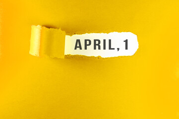 April 1 message on yellow paper, torn. Holiday concept