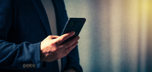 businessman holds a smartphone in his hand, the concept of online communication