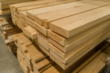 A stack of boards in a hardware store. Wooden products for construction and repair. Assortment of...