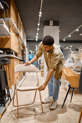 Man is buying folding chair for garden