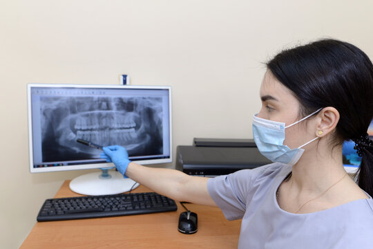 Dentist showing x-ray image to patient