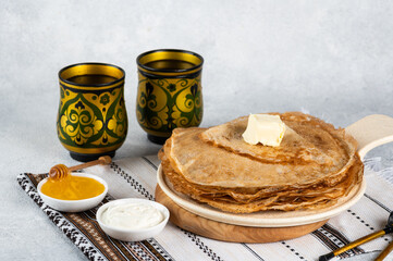 Shrovetide Maslenitsa festival. Russian pancakes blini. Pancakes with honey and jam. Russian spoons. National russian festival. Russian crepes.