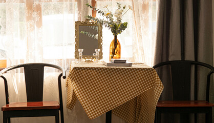 Tables, chairs, lamps, flowers, arranged in the corner of the room perfectly and beautifully.