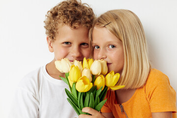 Cute stylish kids with a bouquet of flowers gift birthday holiday childhood light background