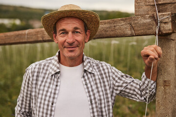 Fototapeta premium Mature farmer in field in summer