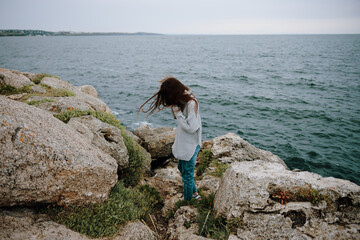 portrait of a woman beach tourism cloudy weather stone coast Relaxation concept