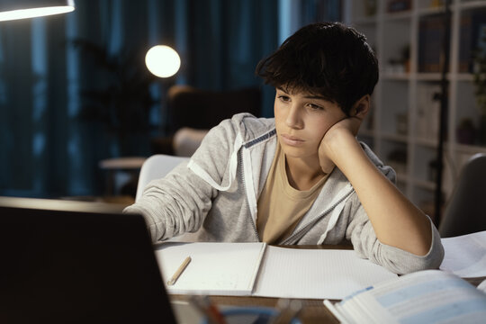 Teenager watching online classes at night