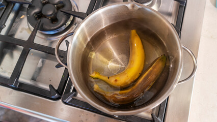 Boiled banana in the pot. High calories snack. Traditional Thai dessert. Boiled banana with banana leaf.