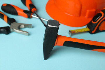 Work tools on blue background, close up