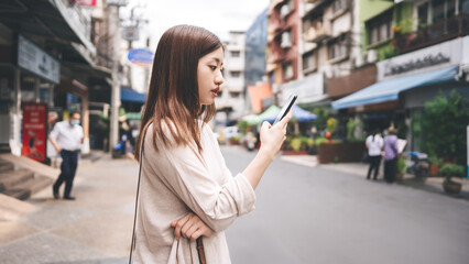 Young adult asian woman using mobile phone for social media application.