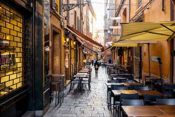 Famous gastronomical street with lots of shops, market and restaurants during the morning time in Bologna city, Italy © rh2010