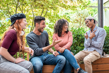 Fototapeta premium young people having fun in a open bistrot, gen z group of friends smiling, laughing and joking