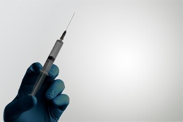 In this photo illustration of a new COVID-19 variant a medical syringe in a hand