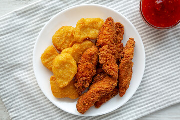 Homemade Nuggets and Chicken Tenders with Sweet and Sour Sauce, top view. Overhead, from above, flat lay.