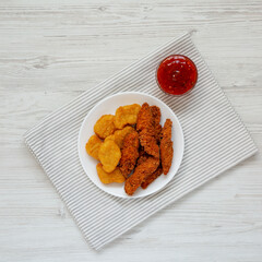 Homemade Nuggets and Chicken Tenders with Sweet and Sour Sauce, top view. Overhead, from above, flat lay.