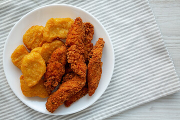 Homemade Nuggets and Chicken Tenders on a Plate, top view. Overhead, from above, flat lay. Copy space.