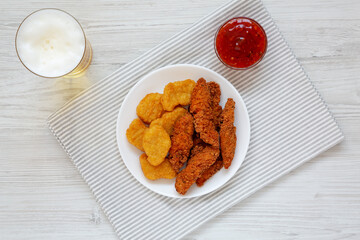 Homemade Nuggets and Chicken Tenders with Sauce and Beer, top view. Overhead, from above, flat lay.