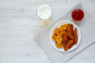 Homemade Nuggets and Chicken Tenders with Sauce and Beer, top view. Overhead, from above, flat lay. Copy space.