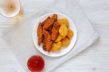 Homemade Nuggets and Chicken Tenders with Sauce and Beer, overhead view. Top view, from above, flat lay.