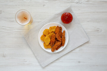 Homemade Nuggets and Chicken Tenders with Sauce and Beer, top view. From above, overhead, flat lay.