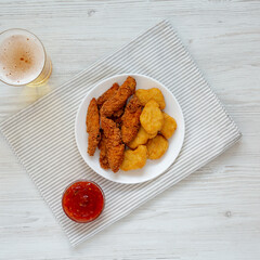 Homemade Nuggets and Chicken Tenders with Sauce and Beer, view from above. Top view, overhead, flat lay.