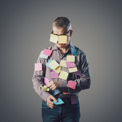 Funny businessman covered with sticky notes