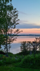 Fototapeta na wymiar sunset over the lake, finnish summer, summer evening, midningt sun