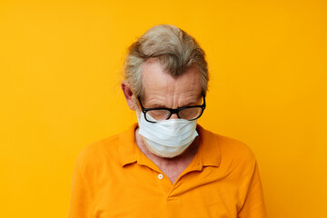 Photo of retired old man with glasses face shield safety isolated background