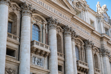 Low angle view of exterior and entrance of Saint Peter's Basilica.