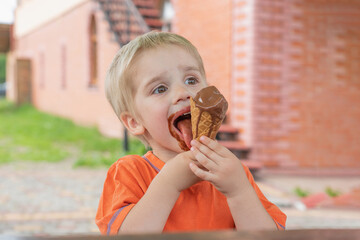 Boy greedily eats chocolate ice cream.