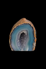 Hollow agate mineral, decorative stone on black background.