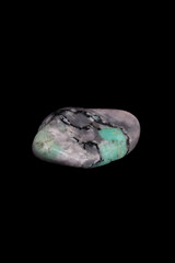 Emerald, mineral stone on black background.