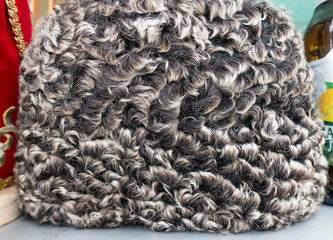 Closeup gray karakul fur hat. Selective focus.