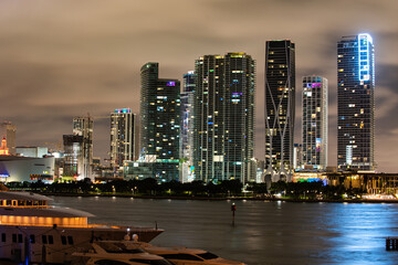 Miami city night. Miami Florida at sunset, skyline of illuminated buildings and Macarthur Causeway...