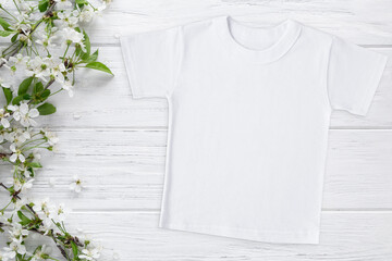 Spring Easter t-shirt mockup with blossom cherry, flat lay on wood background with copy space. Mothers day gift template