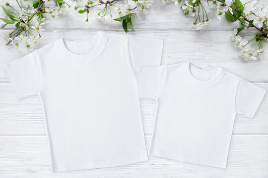 Two spring t-shirt mockup with blossom cherry, flat lay on wood background with copy space. Easter, Mothers day template. Mother and me