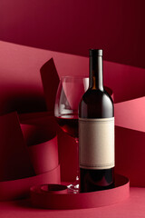 Bottle and glass of red wine.