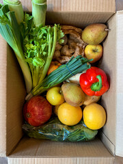 Healthy eating grocery shopping or delivery of fresh fruits and vegetables. Rich vitamin vegetables. Healthy lifestyle, vegan, vegetarian diet, nutrition. Variety of fruits vegetables in a carton box