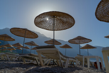 Silhouettes of beach umbrellas at dawn on the seashore in Turkey