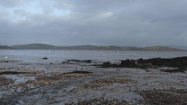 Stream flowing into Balcary Bay, with salmon fishing nets in the background