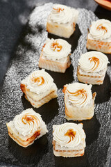 Maki sushi on dark slate. Unagi maki with eel. Sushi roll with eel fish, cream cheese and unagi sauce. Style concept japanese menu with black background, leaves and hard shadow.