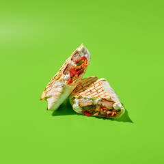 Shawarma with vegetables and meat on green background. Contemporary poster with shawarma. Doner...