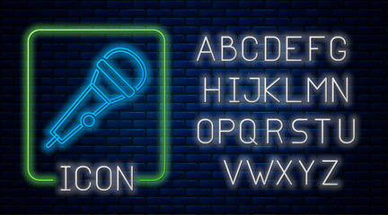 Glowing neon Microphone icon isolated on brick wall background. On air radio mic microphone. Speaker sign. Neon light alphabet. Vector