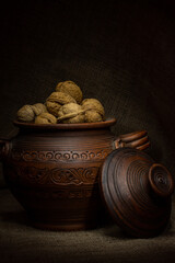 Clay pot with walnuts