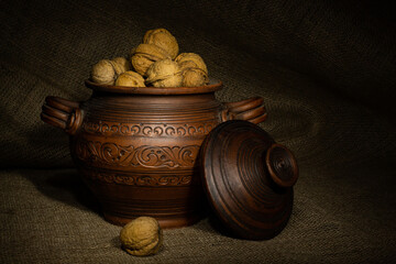 Clay pot with walnuts
