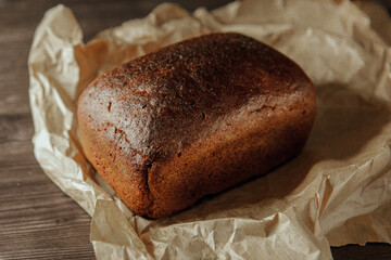 freshly baked black rye bread on a dark background