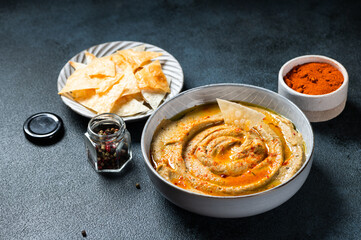 Traditional arabian eggplant dip baba ganoush with herbs and smoked paprika on dark background. Eggplant hummus. Babaganush or eggplant caviar. Baked eggplant. Turkish eggplant dip